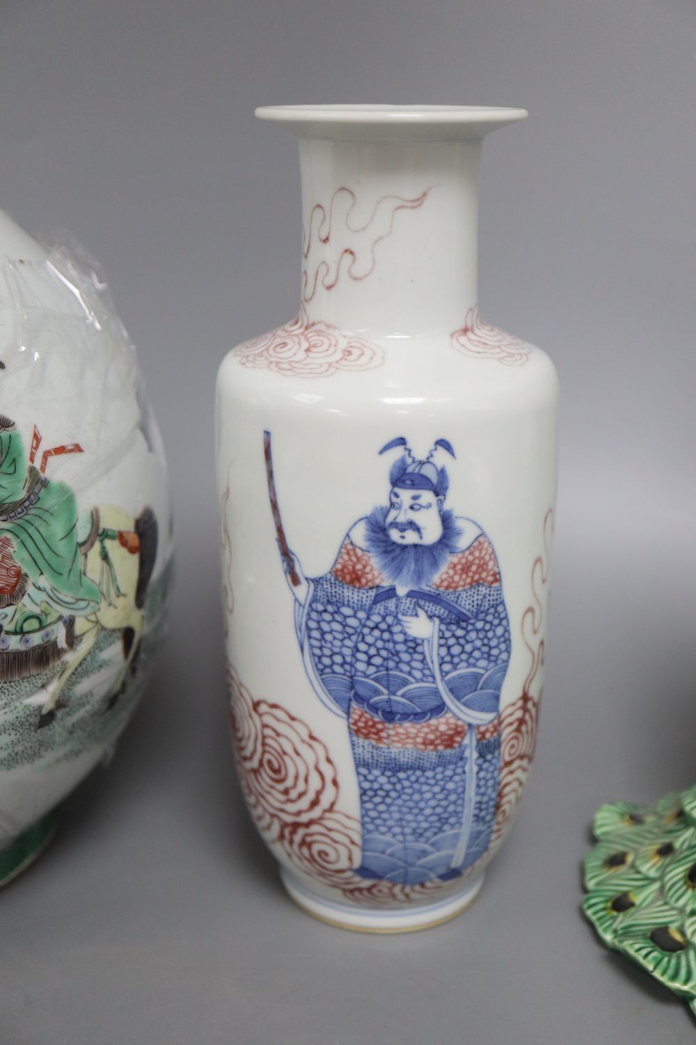 A Chinese famille verte bottle vase, an underglazed copper rouleau vase and a peacock, tallest 38cm